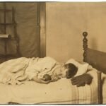 Parent reading a bedtime story to a child in bed, part of a bedtime routine for kids