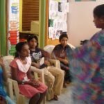 Storyteller sharing a story with a group of children, showing the benefits of storytelling for children