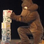 Toddler playing with colourful stacking blocks, one of many educational activities for toddlers