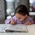 Child concentrating on schoolwork, showing a growth mindset for kids