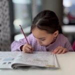 Child concentrating on schoolwork, showing a growth mindset for kids