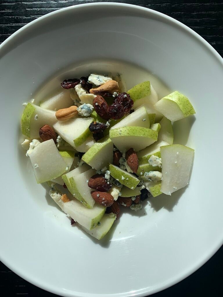 Bowl of fresh fruit and nuts, examples of healthy snacks for kids