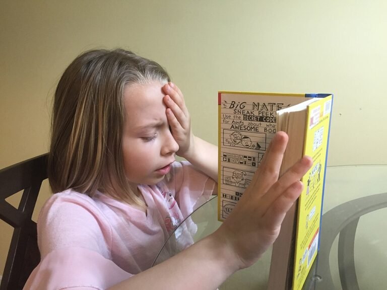 Young child reading a picture book, showing how to build a reading habit in kids