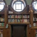 Rows of old books on library shelves, from a magical short story about reading for kids
