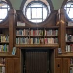 Rows of old books on library shelves, from a magical short story about reading for kids