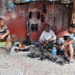 Traditional cobbler repairing shoes on a street, from a short story about contentment for kids