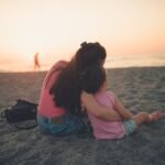 Parent calmly hugging a child, illustrating what is gentle parenting