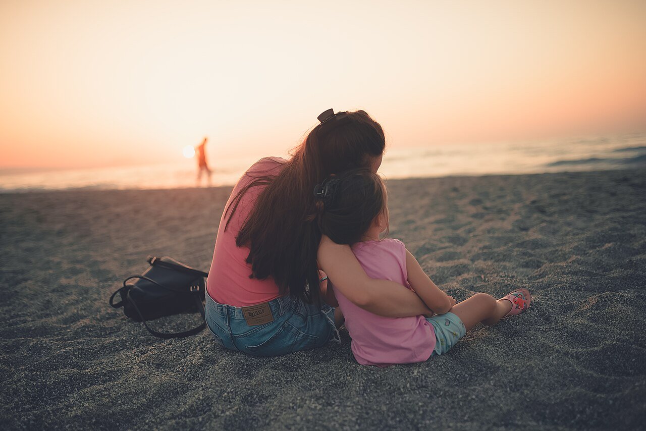 Parent calmly hugging a child, illustrating what is gentle parenting