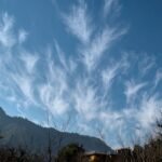 Bright blue sky with white clouds, answering why is the sky blue for kids