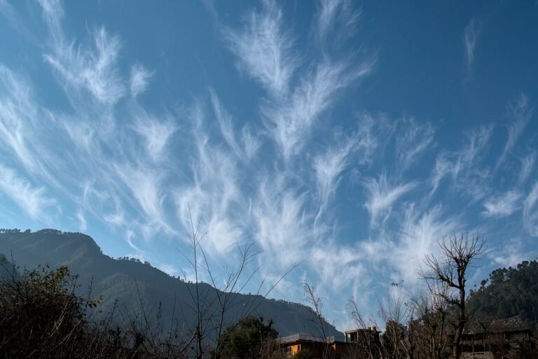 Bright blue sky with white clouds, answering why is the sky blue for kids