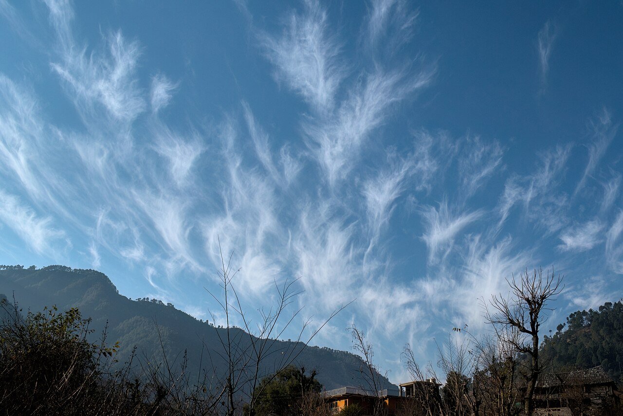 Bright blue sky with white clouds, answering why is the sky blue for kids